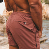 Shorts de baño de secado rápido con ribete en terracota y azul marino